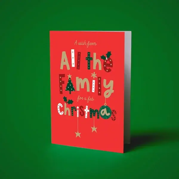 Red Christmas card with colourful festive typography, Christmas tree and holly illustrations, and seasonal decorations on a bright red background.